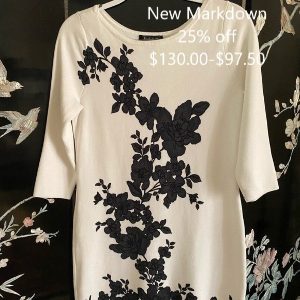 White knit with black flowers on front.